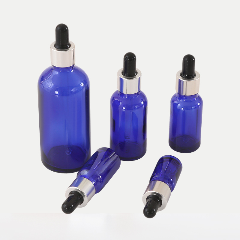 Botella de aceite esencial de vidrio azul