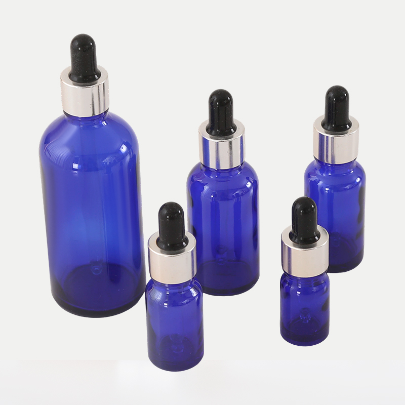 Botella de aceite esencial de vidrio azul