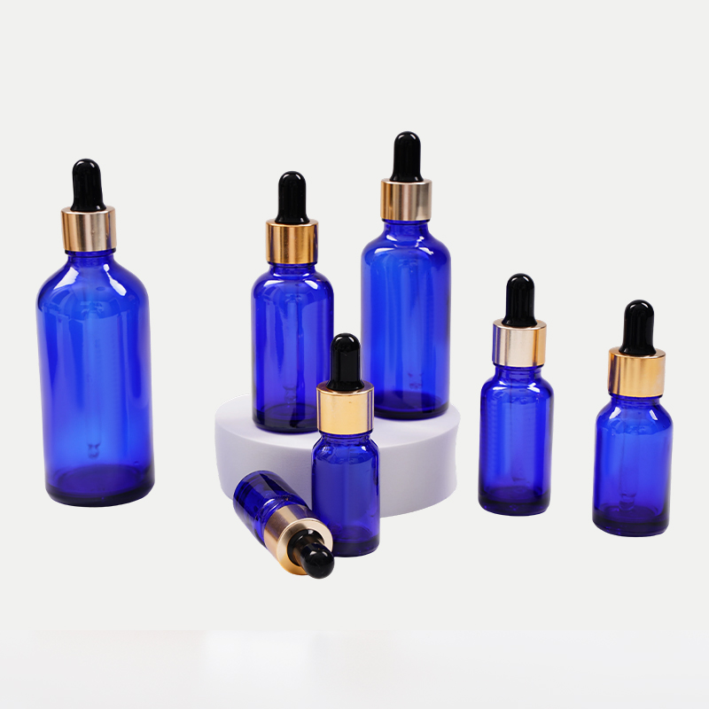 Botella de aceite esencial de vidrio azul