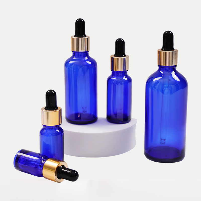 Botella de aceite esencial de vidrio azul