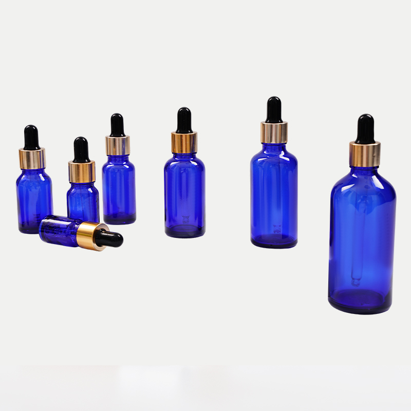 Botella de aceite esencial de vidrio azul
