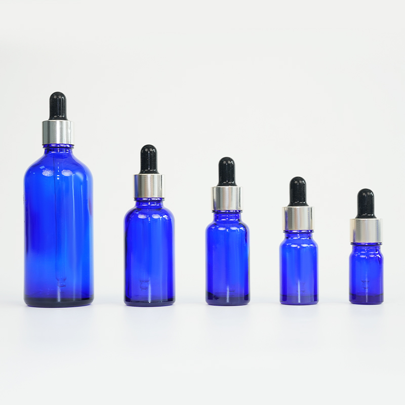 Botella de aceite esencial de vidrio azul